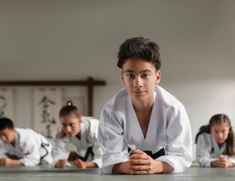full-shot-asian-people-practicing-taekwondo_23-2150753732