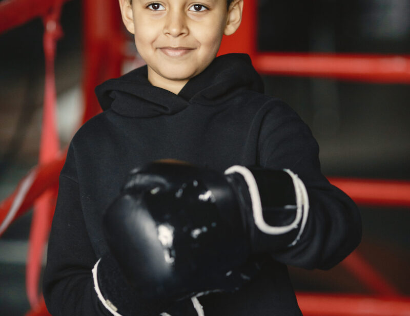 Young hardworking boxer learning to box. Child at sport center. Kid taking up a new hobby